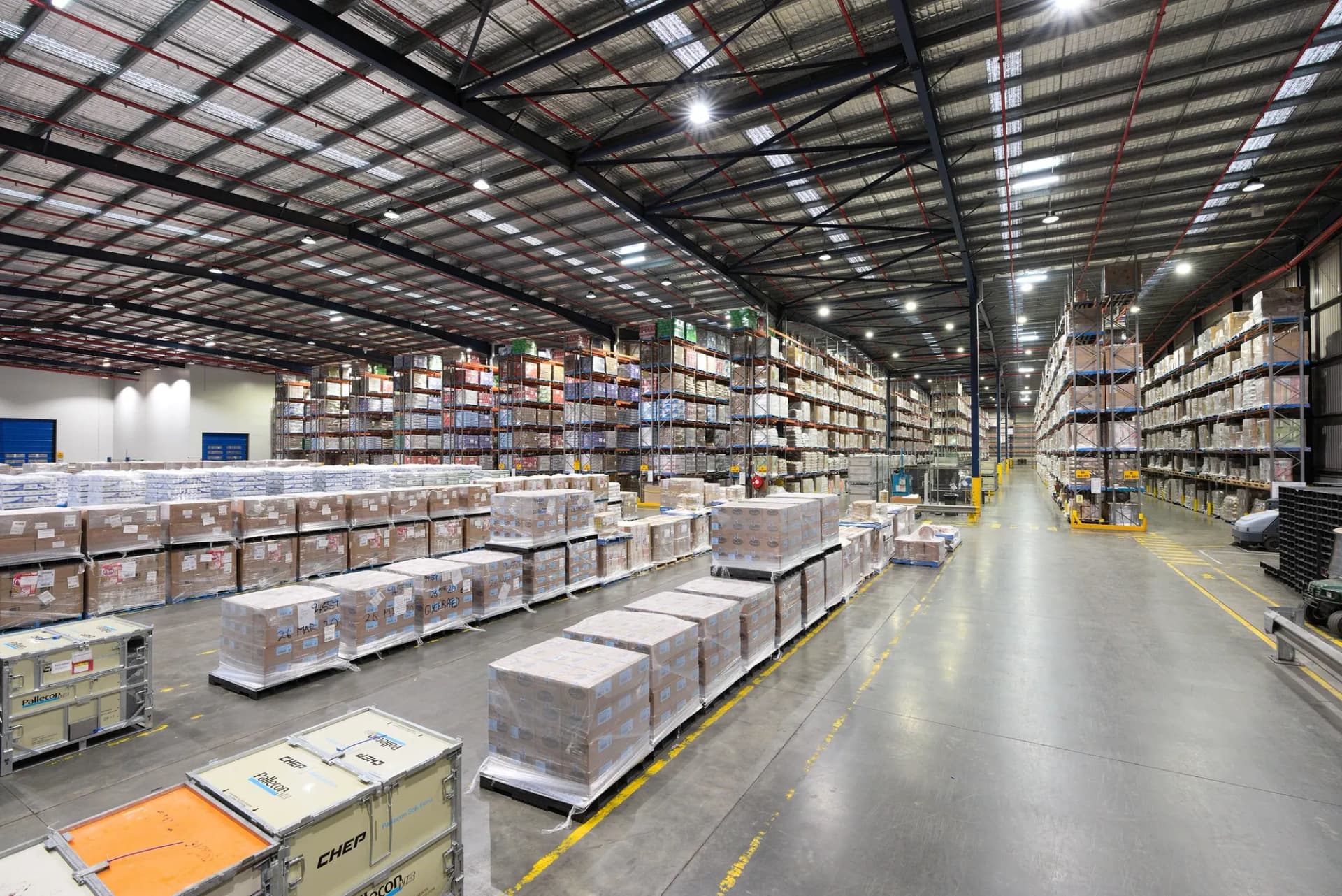 Large distribution warehouse with palletised goods and high-bay shelving