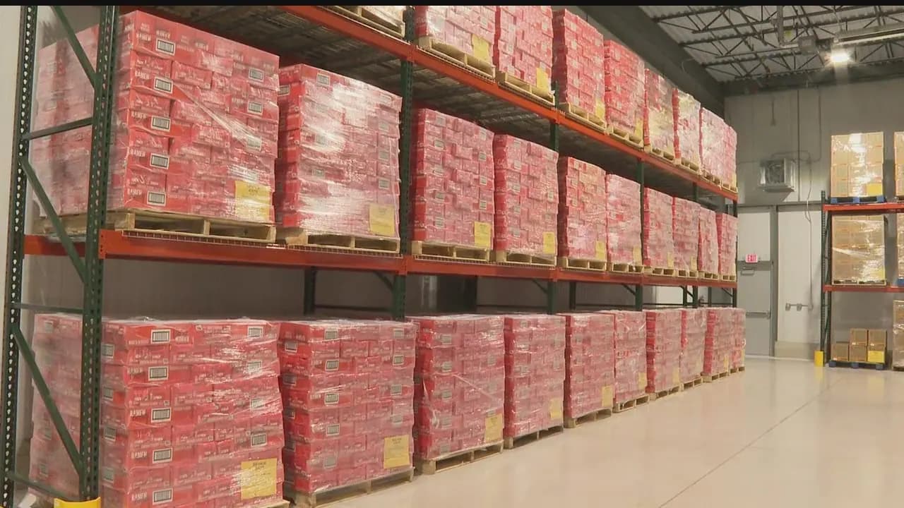Rows of shrink-wrapped cartons on pallet racking
