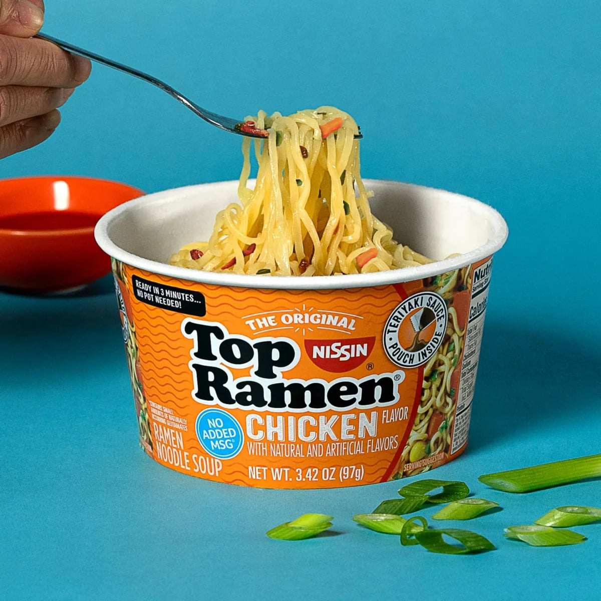 Nissin Top Ramen Chicken bowl with noodles lifted on a fork