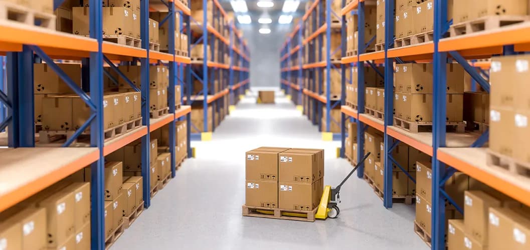 Warehouse aisle lined with racked cartons and a pallet truck